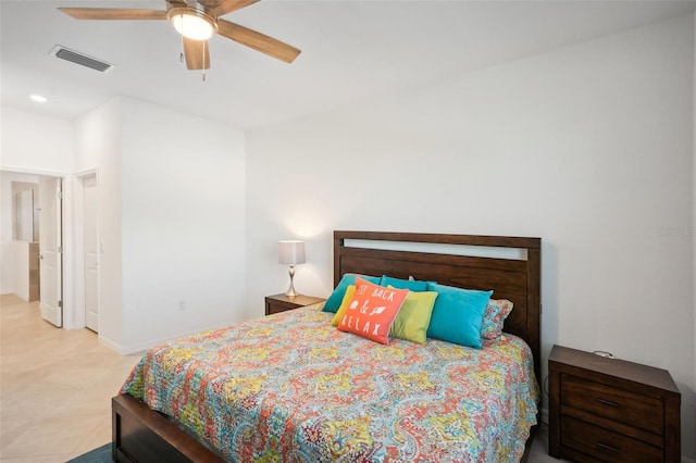 tiled bedroom featuring ceiling fan