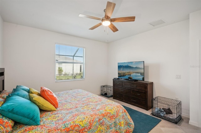 bedroom with ceiling fan and light tile patterned floors