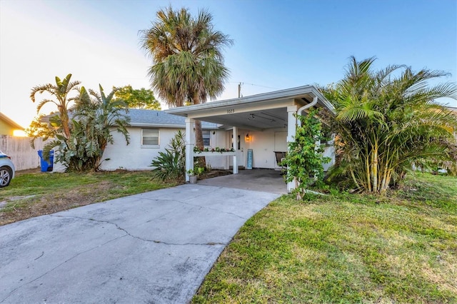 view of front of house with a front lawn and a carport