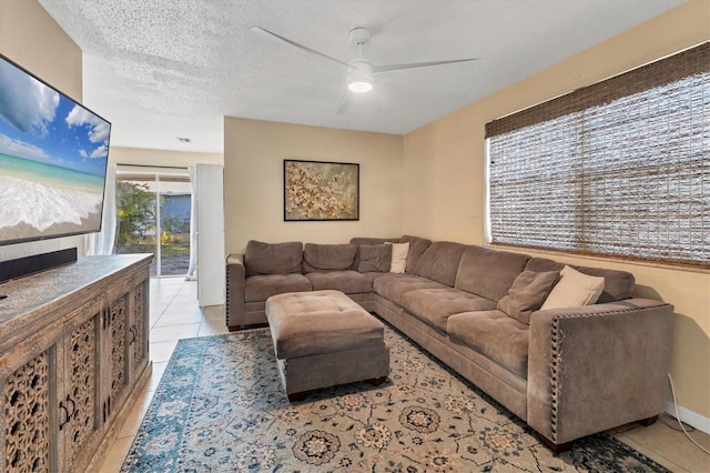 tiled living room featuring ceiling fan and a textured ceiling