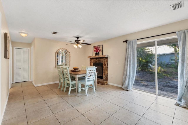 unfurnished dining area featuring a textured ceiling, ceiling fan, and light tile patterned flooring