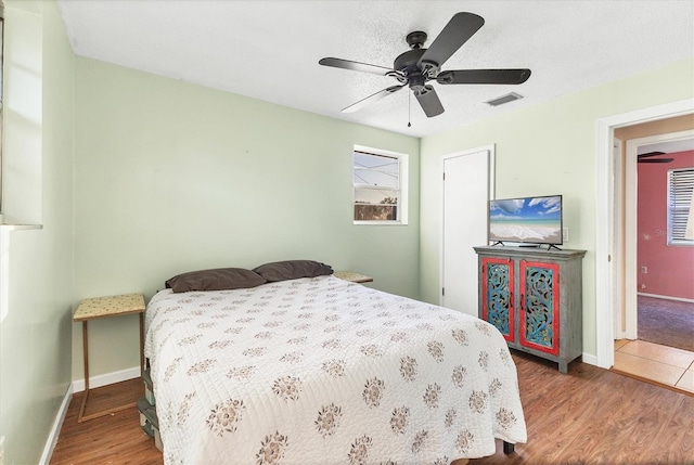 bedroom featuring hardwood / wood-style floors and ceiling fan