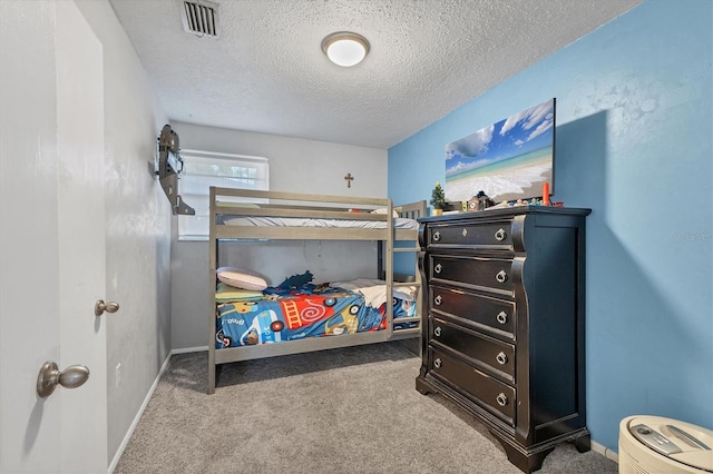 carpeted bedroom featuring a textured ceiling