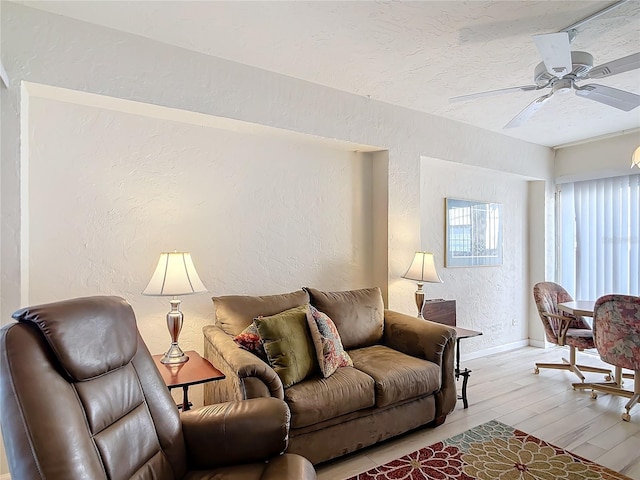 living room with ceiling fan and light hardwood / wood-style floors