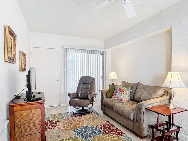 living room featuring wood-type flooring and a textured ceiling