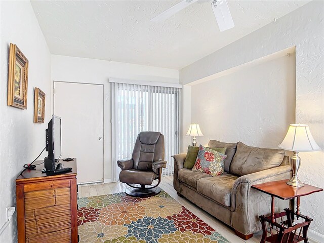 200 Park Blvd N Unit 103, Venice, FL 34285 - living room featuring wood finished floors, a textured wall, and a textured ceiling