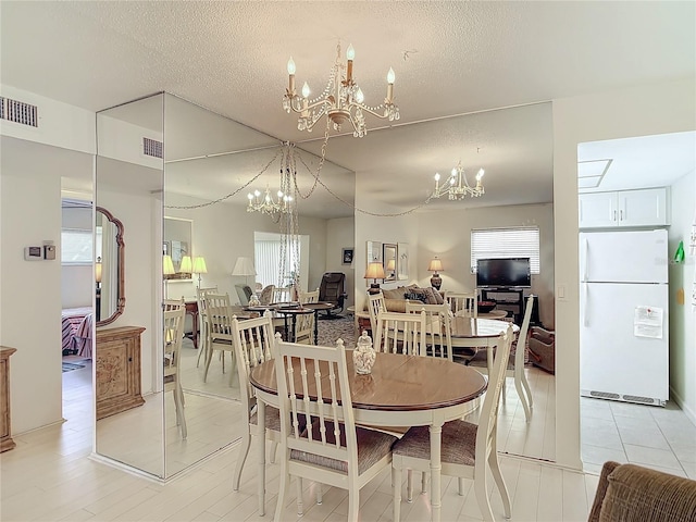 dining room featuring a textured ceiling and plenty of natural light