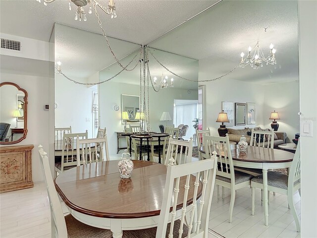 200 Park Blvd N Unit 103, Venice, FL 34285 - dining room featuring a chandelier and a textured ceiling