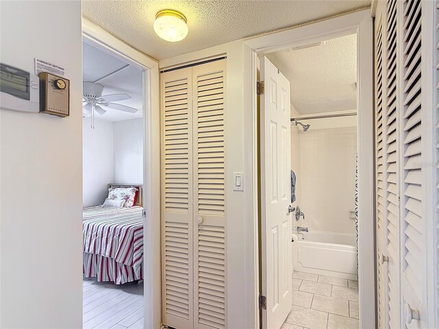 200 Park Blvd N Unit 103, Venice, FL 34285 - hall featuring a textured ceiling and light tile patterned flooring