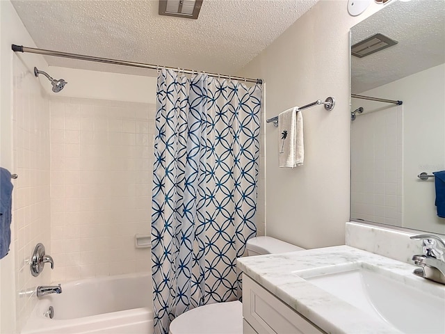 full bathroom with vanity, a textured ceiling, toilet, and shower / tub combo