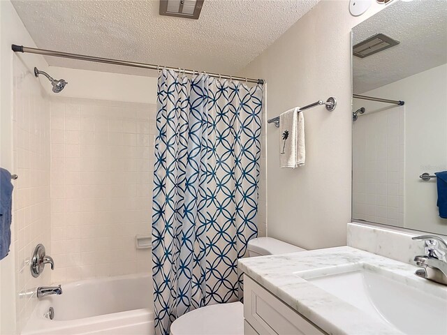 200 Park Blvd N Unit 103, Venice, FL 34285 - bathroom featuring a textured ceiling, toilet, shower / tub combo, and vanity