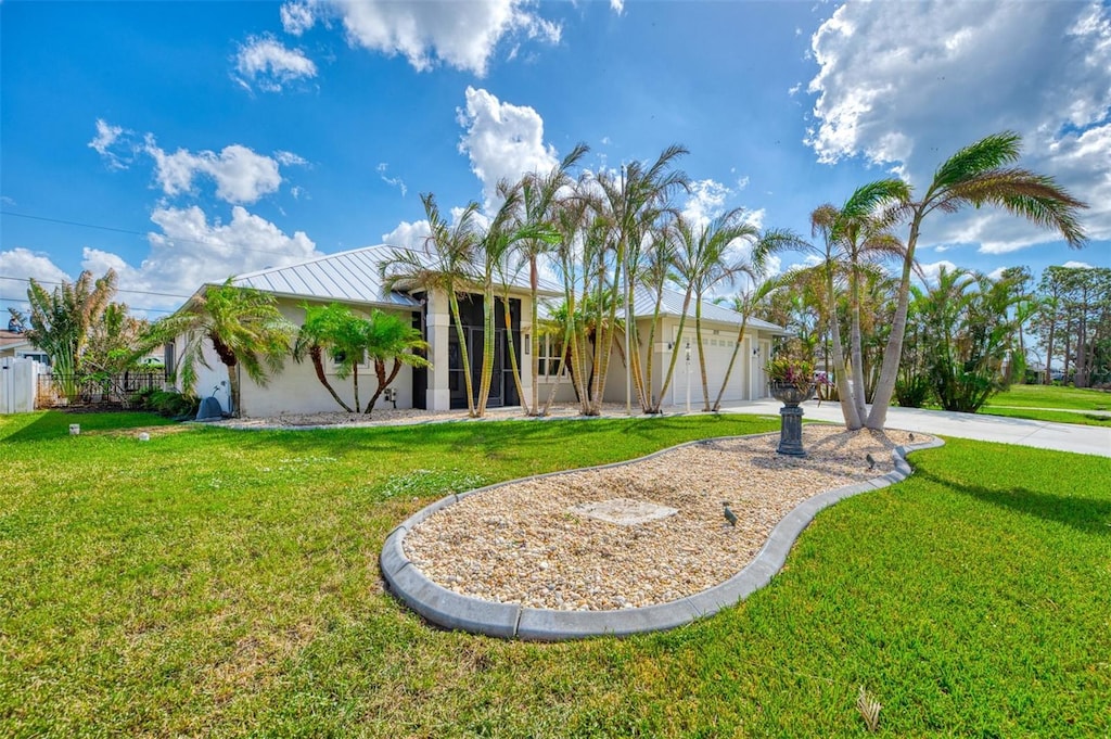 view of front of home with a garage and a front lawn