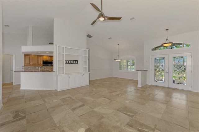 1219 Nantucket Rd, Venice, FL 34293 - unfurnished living room featuring high vaulted ceiling, ceiling fan, french doors, baseboards, and a sink