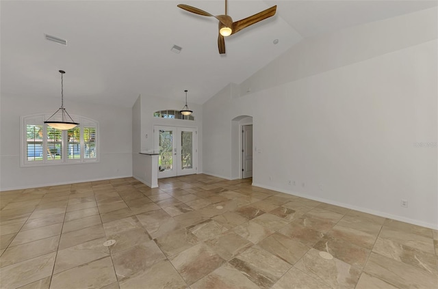 1219 Nantucket Rd, Venice, FL 34293 - unfurnished living room with a ceiling fan, arched walkways, french doors, high vaulted ceiling, and baseboards