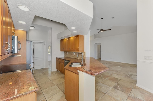 1219 Nantucket Rd, Venice, FL 34293 - kitchen with a sink, arched walkways, ceiling fan, appliances with stainless steel finishes, and decorative backsplash