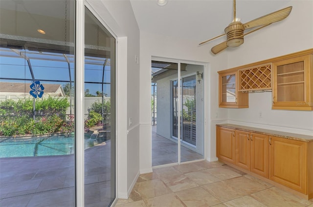 1219 Nantucket Rd, Venice, FL 34293 - doorway with ceiling fan, baseboards, and light stone finish flooring