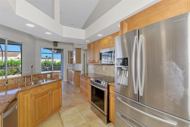 1219 Nantucket Rd, Venice, FL 34293 - kitchen featuring stainless steel appliances, a sink, light stone counters, tasteful backsplash, and recessed lighting