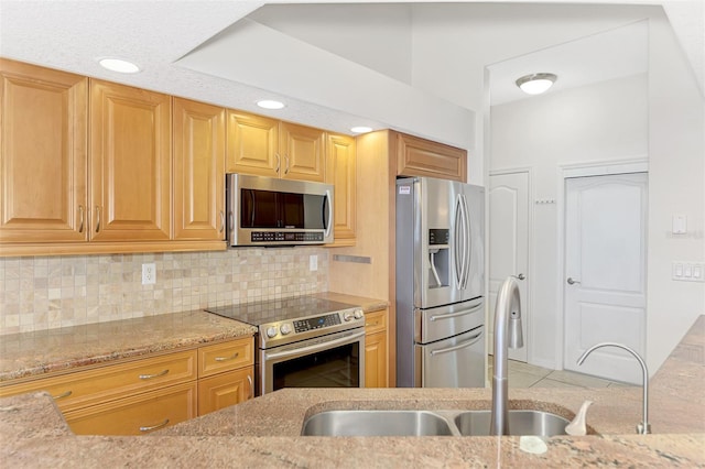 1219 Nantucket Rd, Venice, FL 34293 - kitchen featuring stainless steel appliances, a sink, light stone countertops, and backsplash