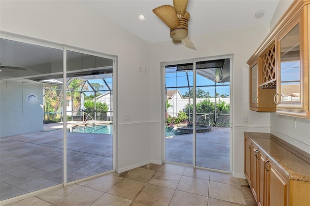 1219 Nantucket Rd, Venice, FL 34293 - doorway featuring a ceiling fan, a sunroom, plenty of natural light, and baseboards