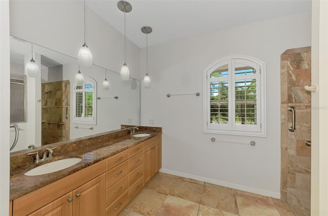 1219 Nantucket Rd, Venice, FL 34293 - full bath with healthy amount of natural light, a tile shower, double vanity, and baseboards