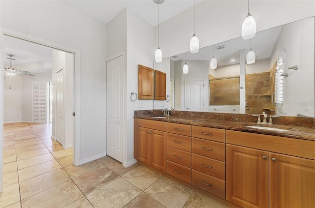 1219 Nantucket Rd, Venice, FL 34293 - full bath with a tile shower, double vanity, ceiling fan, and baseboards