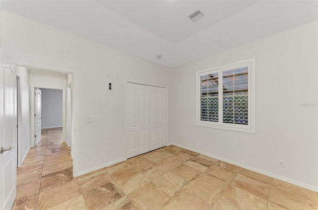 1219 Nantucket Rd, Venice, FL 34293 - unfurnished bedroom featuring baseboards, light stone finish floors, and a closet