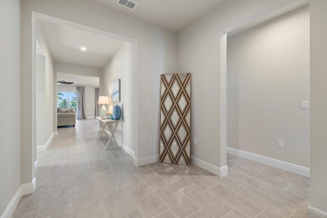 11925 Bohemian Pl, Venice, FL 34293 - corridor featuring baseboards, recessed lighting, and light tile patterned flooring