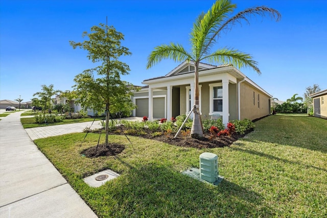 view of front of home featuring a garage and a front lawn