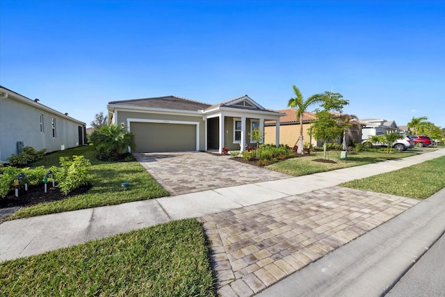 single story home featuring a garage and a front yard