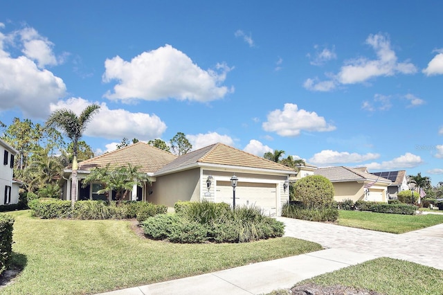 view of front facade with a garage and a front lawn