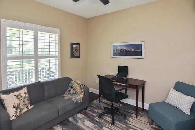 office space featuring ceiling fan and dark hardwood / wood-style floors