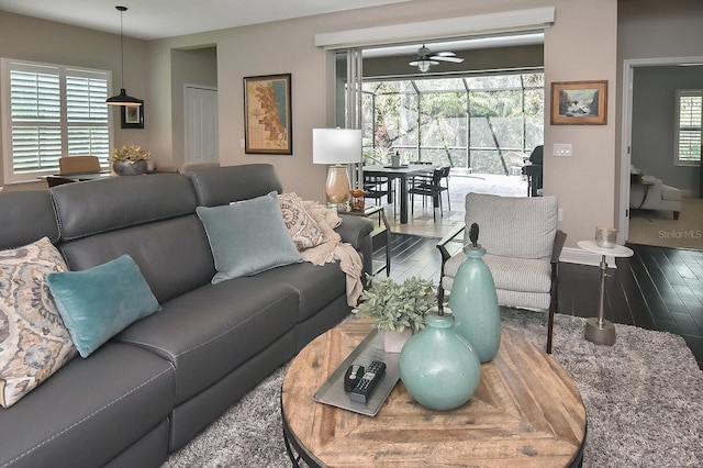 living room featuring wood-type flooring and ceiling fan