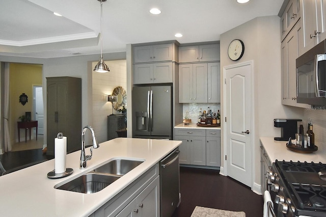 kitchen featuring gray cabinets, stainless steel appliances, sink, and decorative light fixtures