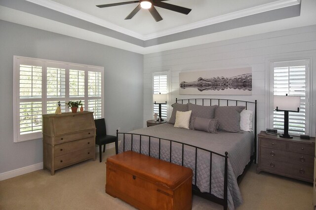 bedroom with ceiling fan, multiple windows, and light carpet