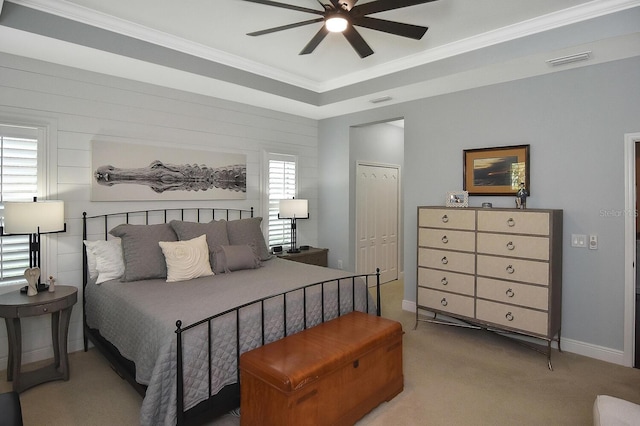 bedroom with carpet floors, ceiling fan, crown molding, and a closet