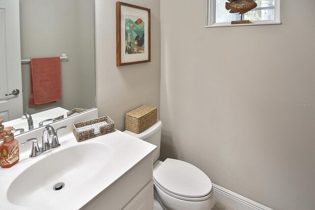 bathroom featuring toilet and vanity