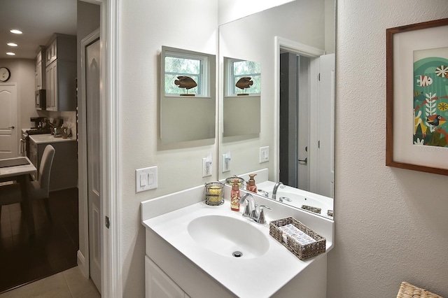 bathroom with tile patterned flooring and vanity