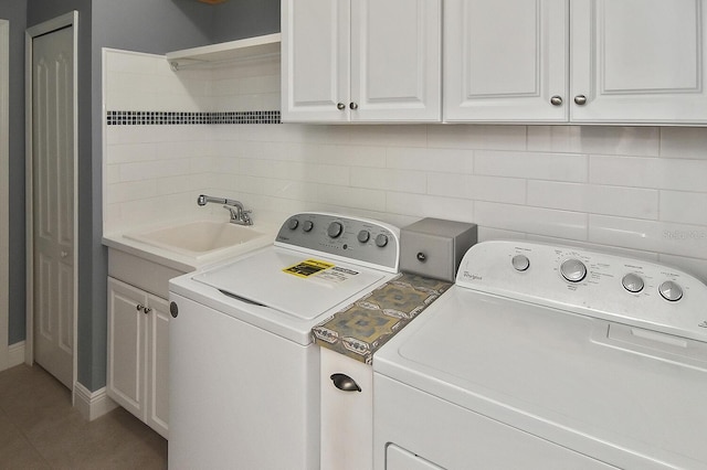 washroom featuring washer and clothes dryer, cabinets, and sink