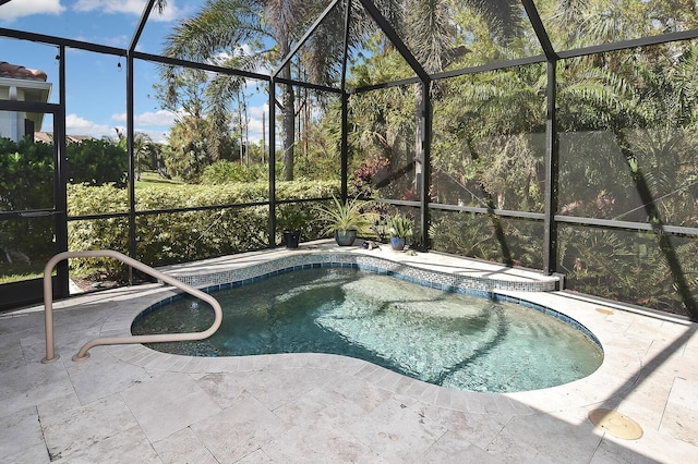 view of swimming pool featuring a lanai and a patio