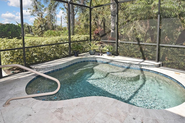 view of swimming pool featuring glass enclosure and a patio