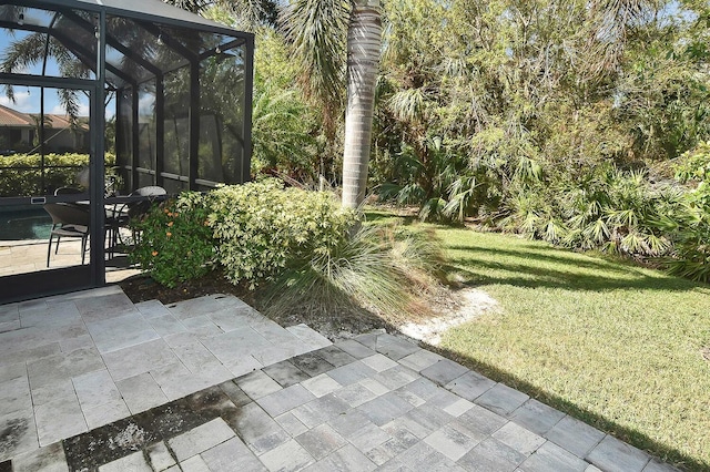 view of yard featuring a lanai and a patio