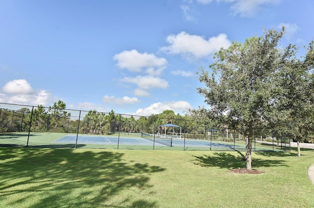 view of sport court with a lawn