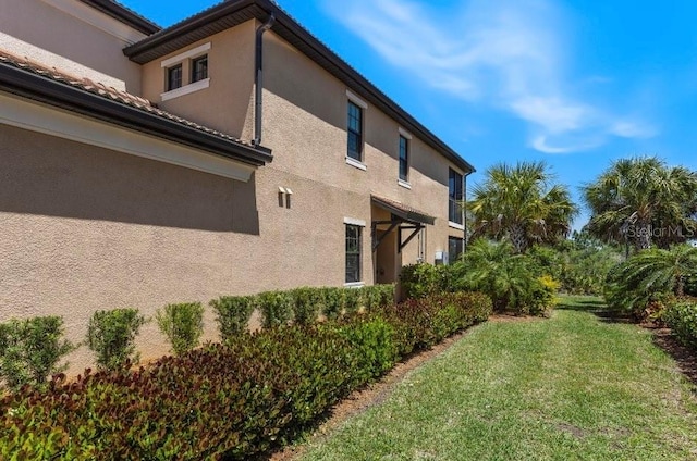 view of property exterior featuring a yard and stucco siding