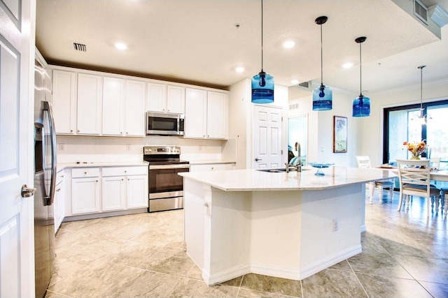 kitchen with appliances with stainless steel finishes, white cabinetry, and decorative light fixtures