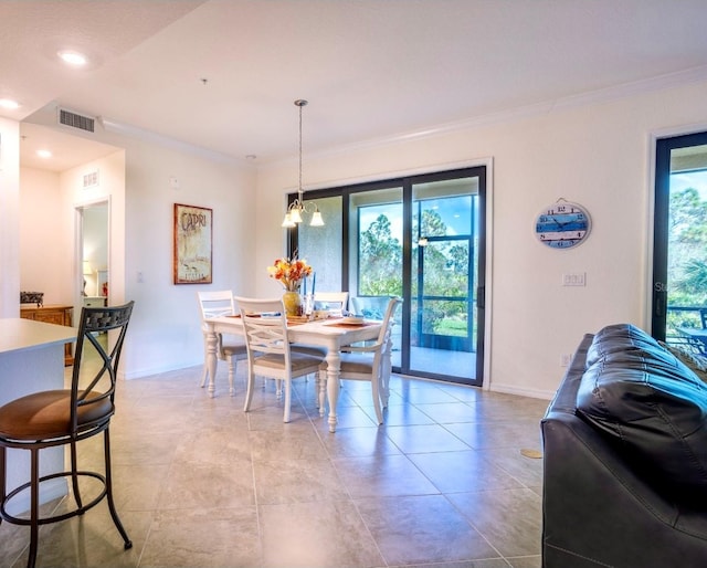 dining room with crown molding, baseboards, and a wealth of natural light