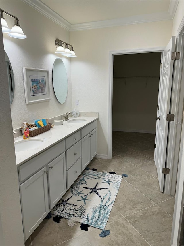 full bath featuring a sink, double vanity, a walk in closet, and crown molding