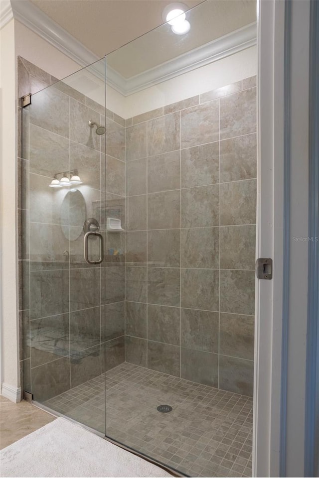 full bath featuring a stall shower and crown molding