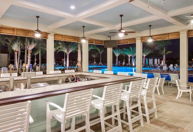 exterior space featuring a ceiling fan and a community pool