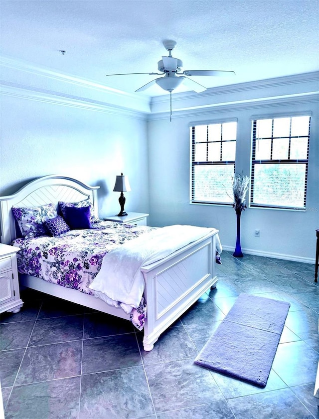 bedroom featuring a textured ceiling, ornamental molding, a ceiling fan, and baseboards