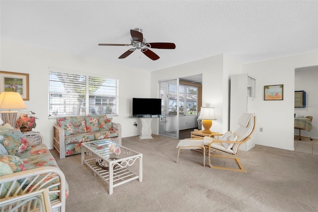 605 Apple Ln, Englewood, FL 34223 - living area featuring plenty of natural light, ceiling fan, carpet flooring, and a textured ceiling